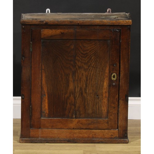 2086 - An 18th century oak wall cupboard, probably Welsh, rectangular panel door enclosing a compartmented ... 