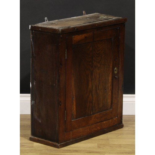 2086 - An 18th century oak wall cupboard, probably Welsh, rectangular panel door enclosing a compartmented ... 