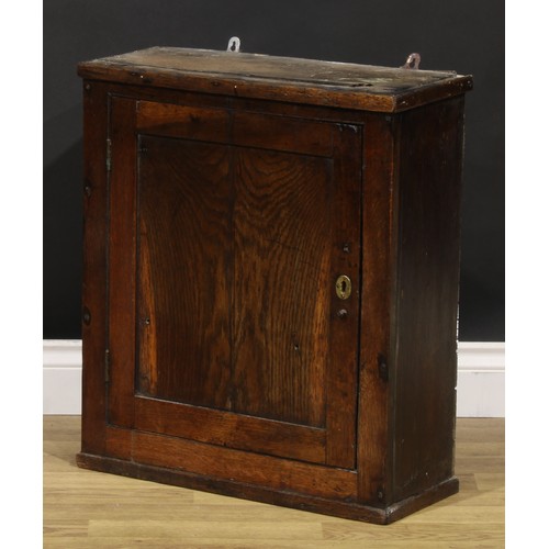 2086 - An 18th century oak wall cupboard, probably Welsh, rectangular panel door enclosing a compartmented ... 