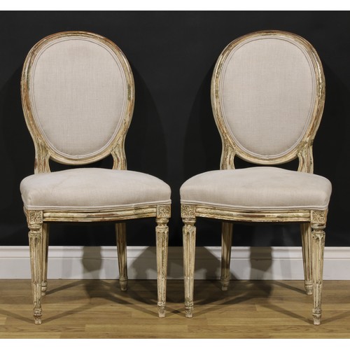 1596 - A pair of French Neoclassical painted softwood side chairs, stuffed-over upholstery, stop-fluted leg... 