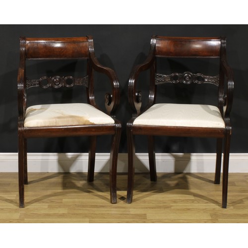 1602 - A pair of Regency mahogany armchairs, each mid-rail centred by a draught-turned roundel, sabre legs,... 