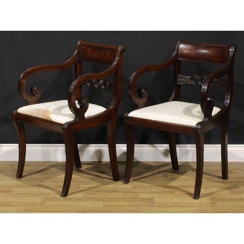 1602 - A pair of Regency mahogany armchairs, each mid-rail centred by a draught-turned roundel, sabre legs,... 