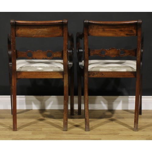 1602 - A pair of Regency mahogany armchairs, each mid-rail centred by a draught-turned roundel, sabre legs,... 