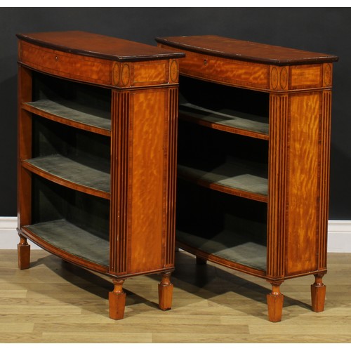 1604 - A pair of Sheraton Revival tulipwood banded satinwood library pier bookcases, each with a slightly o... 