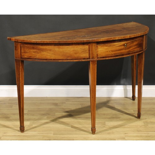 1633 - A George III mahogany demilune serving table, crossbanded top above a deep frieze with single drawer... 