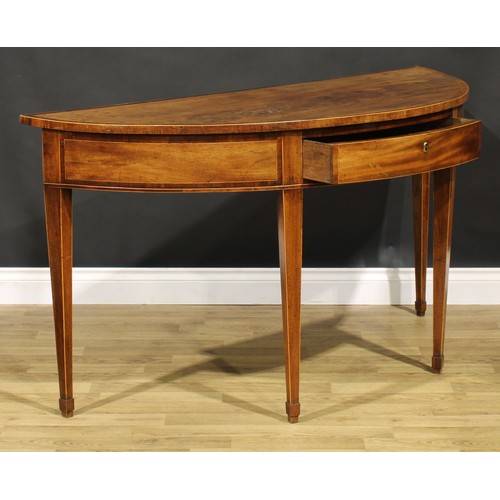 1633 - A George III mahogany demilune serving table, crossbanded top above a deep frieze with single drawer... 