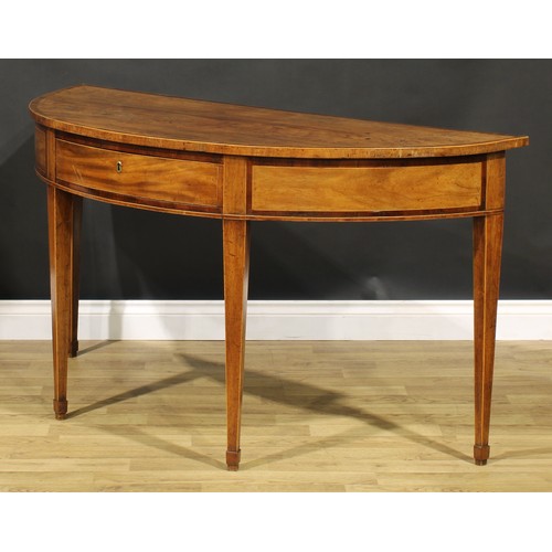 1633 - A George III mahogany demilune serving table, crossbanded top above a deep frieze with single drawer... 