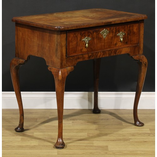 1589 - A George I walnut lowboy, quarter-veneered crossbanded top with reentrant angles, above a long friez... 