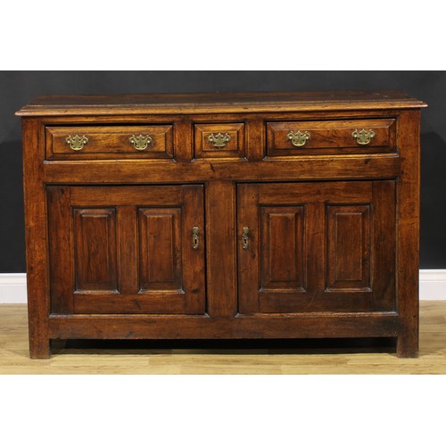 2122 - An 18th century oak low dresser, slightly oversailing top above three frieze drawers and a pair of r... 