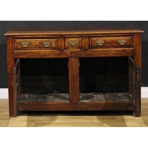 2122 - An 18th century oak low dresser, slightly oversailing top above three frieze drawers and a pair of r... 