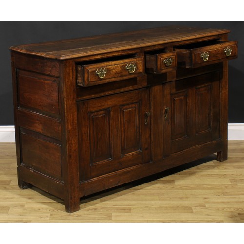 2122 - An 18th century oak low dresser, slightly oversailing top above three frieze drawers and a pair of r... 