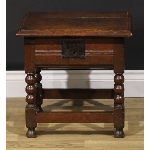 2123 - An 18th century oak box stool, hinged top enclosing a compartmented interior, bobbin-turned and bloc... 