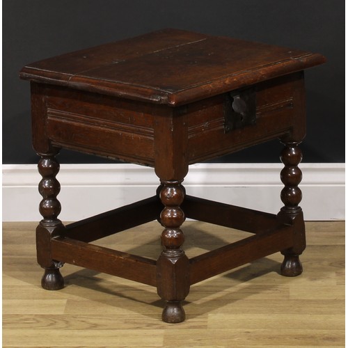 2123 - An 18th century oak box stool, hinged top enclosing a compartmented interior, bobbin-turned and bloc... 