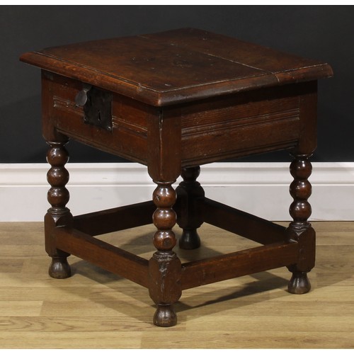 2123 - An 18th century oak box stool, hinged top enclosing a compartmented interior, bobbin-turned and bloc... 