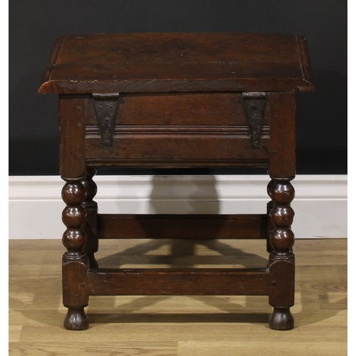 2123 - An 18th century oak box stool, hinged top enclosing a compartmented interior, bobbin-turned and bloc... 