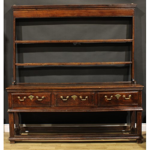 2124 - An 18th century oak dresser, moulded cornice above two plate racks, the projecting base with three f... 