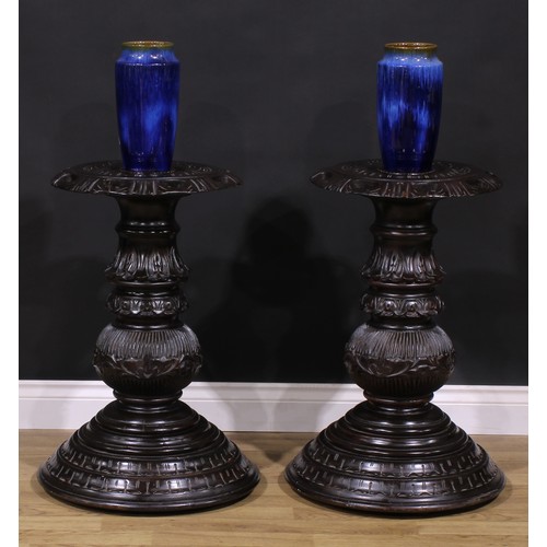 1598 - A pair of hardwood statuary pedestals, each with a shaped circular draught-turned plateau carved wit... 