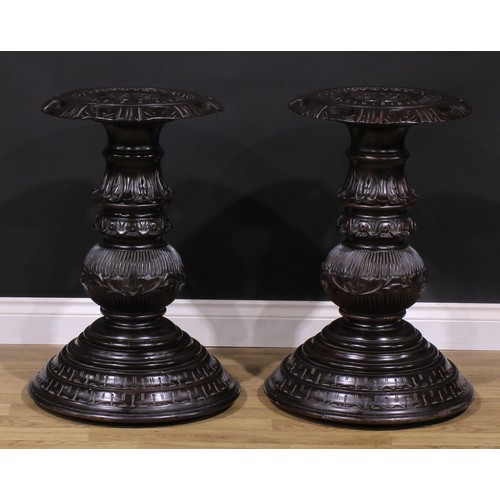 1598 - A pair of hardwood statuary pedestals, each with a shaped circular draught-turned plateau carved wit... 