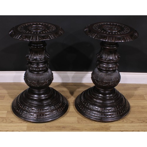 1598 - A pair of hardwood statuary pedestals, each with a shaped circular draught-turned plateau carved wit... 