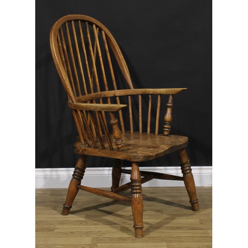 1581 - A beech, ash and elm Windsor elbow chair, hoop back, turned arm posts, saddle seat, turned legs, H-s... 