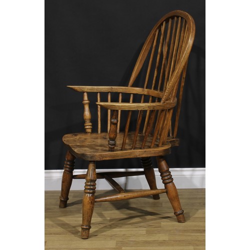 1581 - A beech, ash and elm Windsor elbow chair, hoop back, turned arm posts, saddle seat, turned legs, H-s... 