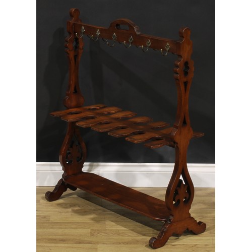 2150 - A Victorian walnut country house riding crop and boot rack, shaped and pierced end supports, scroll ... 