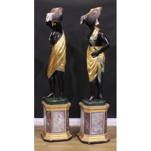 1607 - A pair of Venetian parcel-gilt and polychrome painted blackamoor torcheres, each carved as a Nubian ... 