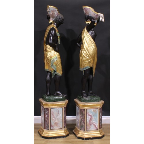 1607 - A pair of Venetian parcel-gilt and polychrome painted blackamoor torcheres, each carved as a Nubian ... 