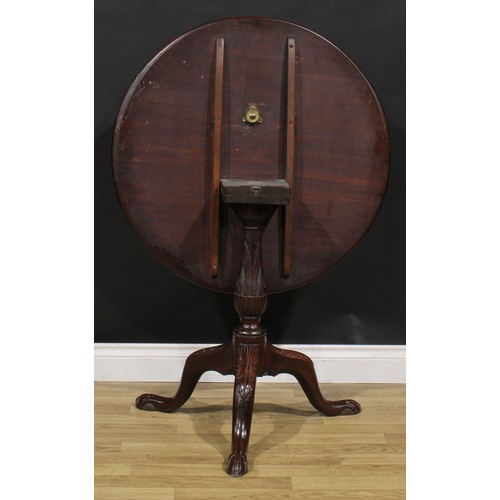 2108 - A George III Revival mahogany tripod supper table, shaped circular tilting top, carved with borders ... 