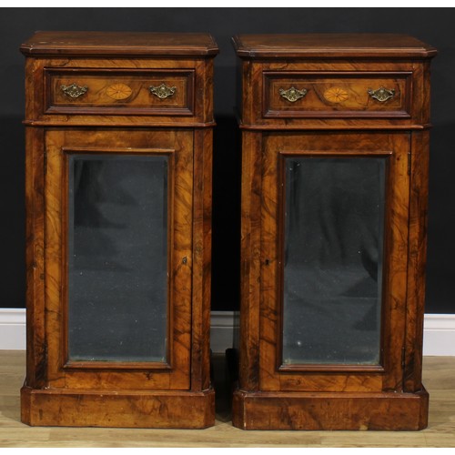 1609 - A pair of Victorian walnut and marquetry pedestal cabinets, each canted rectangular top above a frie... 