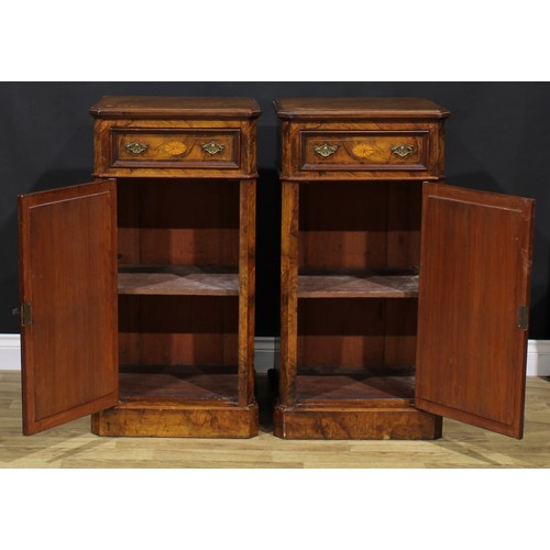 1609 - A pair of Victorian walnut and marquetry pedestal cabinets, each canted rectangular top above a frie... 