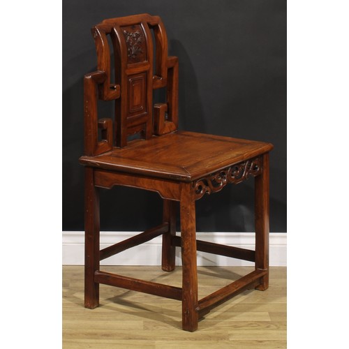 1630 - A Chinese hardwood chair, the back carved with scrolls and blossoming prunus, shaped and pierced apr... 