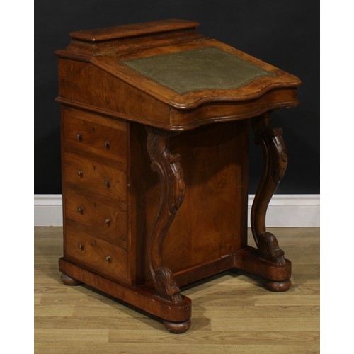 2066 - A Victorian walnut Davenport desk, hinged superstructure enclosing stationery divisions, the hinged ... 