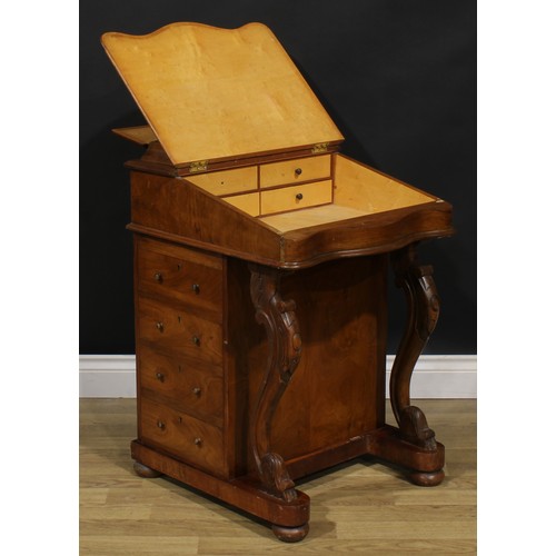 2066 - A Victorian walnut Davenport desk, hinged superstructure enclosing stationery divisions, the hinged ... 