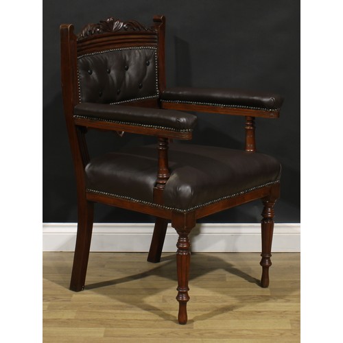 1599 - A pair of late Victorian walnut library chairs, each with a shaped cresting rail carved with acanthu... 