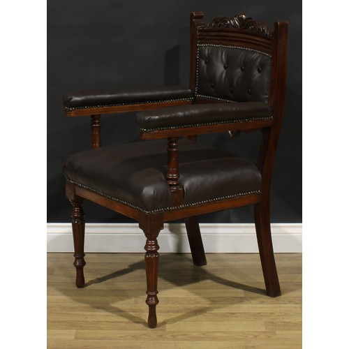 1599 - A pair of late Victorian walnut library chairs, each with a shaped cresting rail carved with acanthu... 