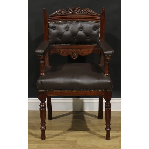 1599 - A pair of late Victorian walnut library chairs, each with a shaped cresting rail carved with acanthu... 