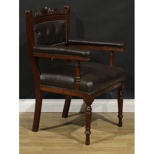 1599 - A pair of late Victorian walnut library chairs, each with a shaped cresting rail carved with acanthu... 