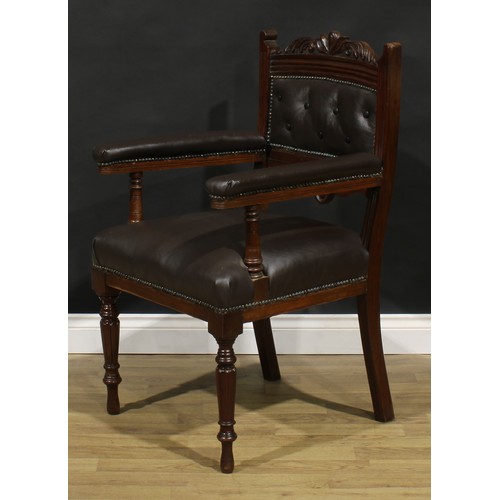 1599 - A pair of late Victorian walnut library chairs, each with a shaped cresting rail carved with acanthu... 