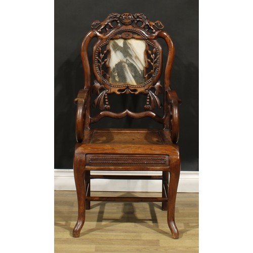 1629 - A Chinese hardwood armchair, shaped creating rail carved with a pair of lions, the back set with a d... 