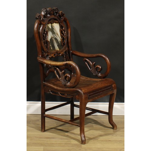 1629 - A Chinese hardwood armchair, shaped creating rail carved with a pair of lions, the back set with a d... 