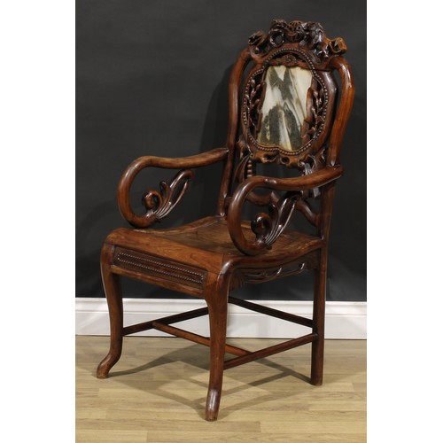 1629 - A Chinese hardwood armchair, shaped creating rail carved with a pair of lions, the back set with a d... 