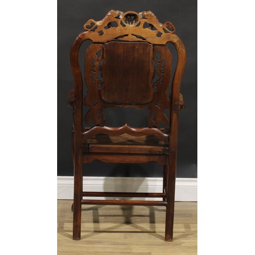 1629 - A Chinese hardwood armchair, shaped creating rail carved with a pair of lions, the back set with a d... 