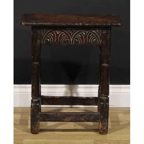 1624 - A Charles II oak joint stool, oversailing top above a deep frieze carved with leafy lunettes, turned... 