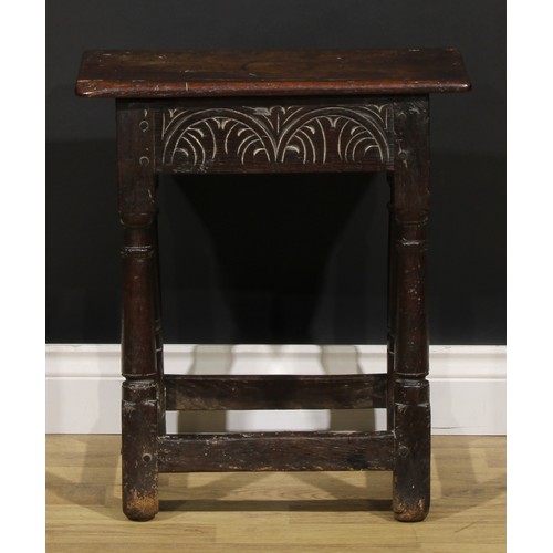 1624 - A Charles II oak joint stool, oversailing top above a deep frieze carved with leafy lunettes, turned... 