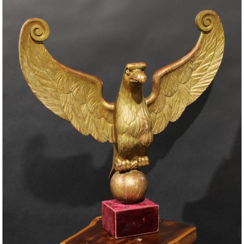 2042 - Interior Decoration - a carved and giltwood architectural fragment, as an eagle, perched on an orb w... 