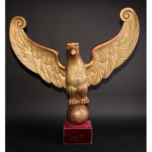 2042 - Interior Decoration - a carved and giltwood architectural fragment, as an eagle, perched on an orb w... 