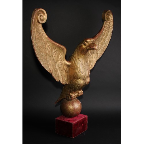 2042 - Interior Decoration - a carved and giltwood architectural fragment, as an eagle, perched on an orb w... 