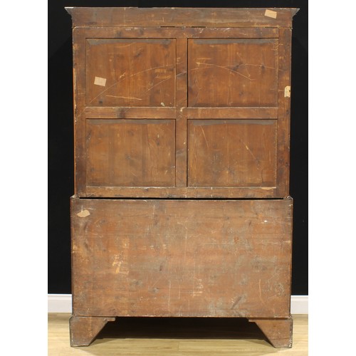 1635 - A George III mahogany linen press, dentil cornice above a pair of rectangular doors enclosing slidin... 