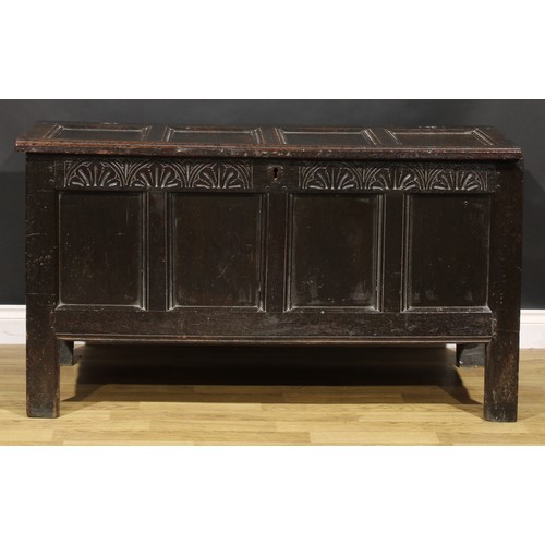 1623 - A Charles II oak four panel blanket chest, hinged top above a lunette carved frieze, stile feet, 75c... 